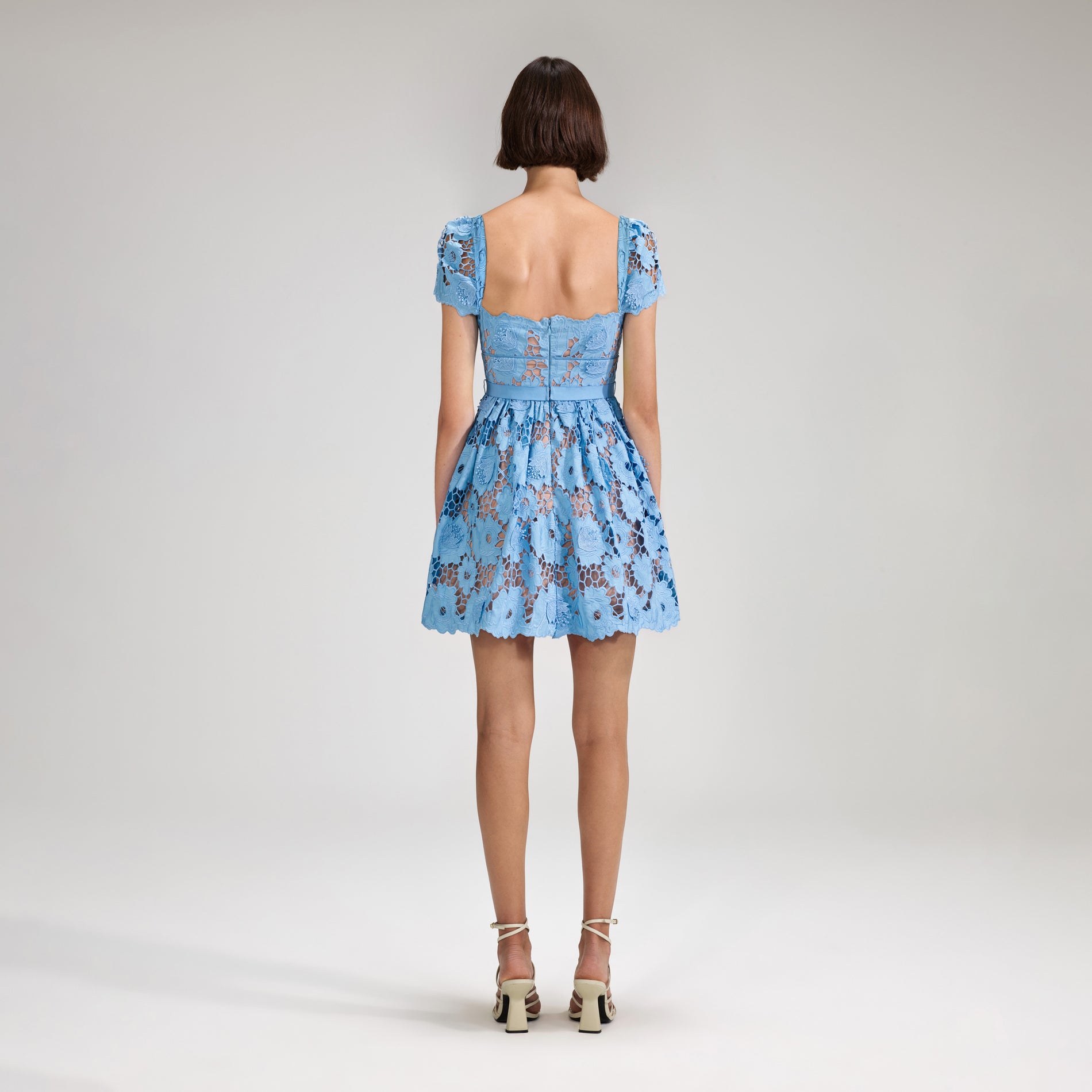 A woman wearing the Blue 3D Cotton Lace Mini Dress