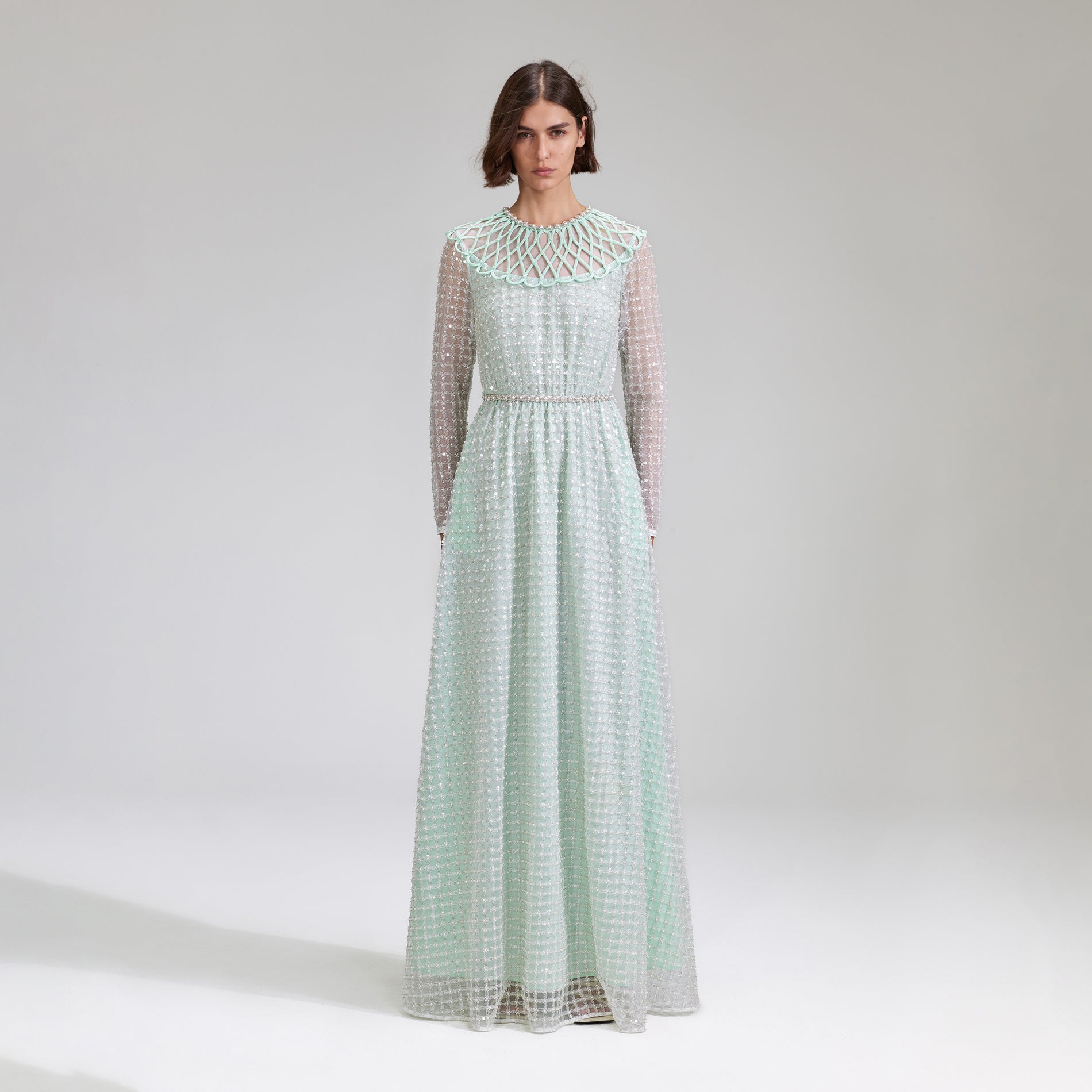 A woman wearing the Mint Grid Sequin Pearl Maxi Dress