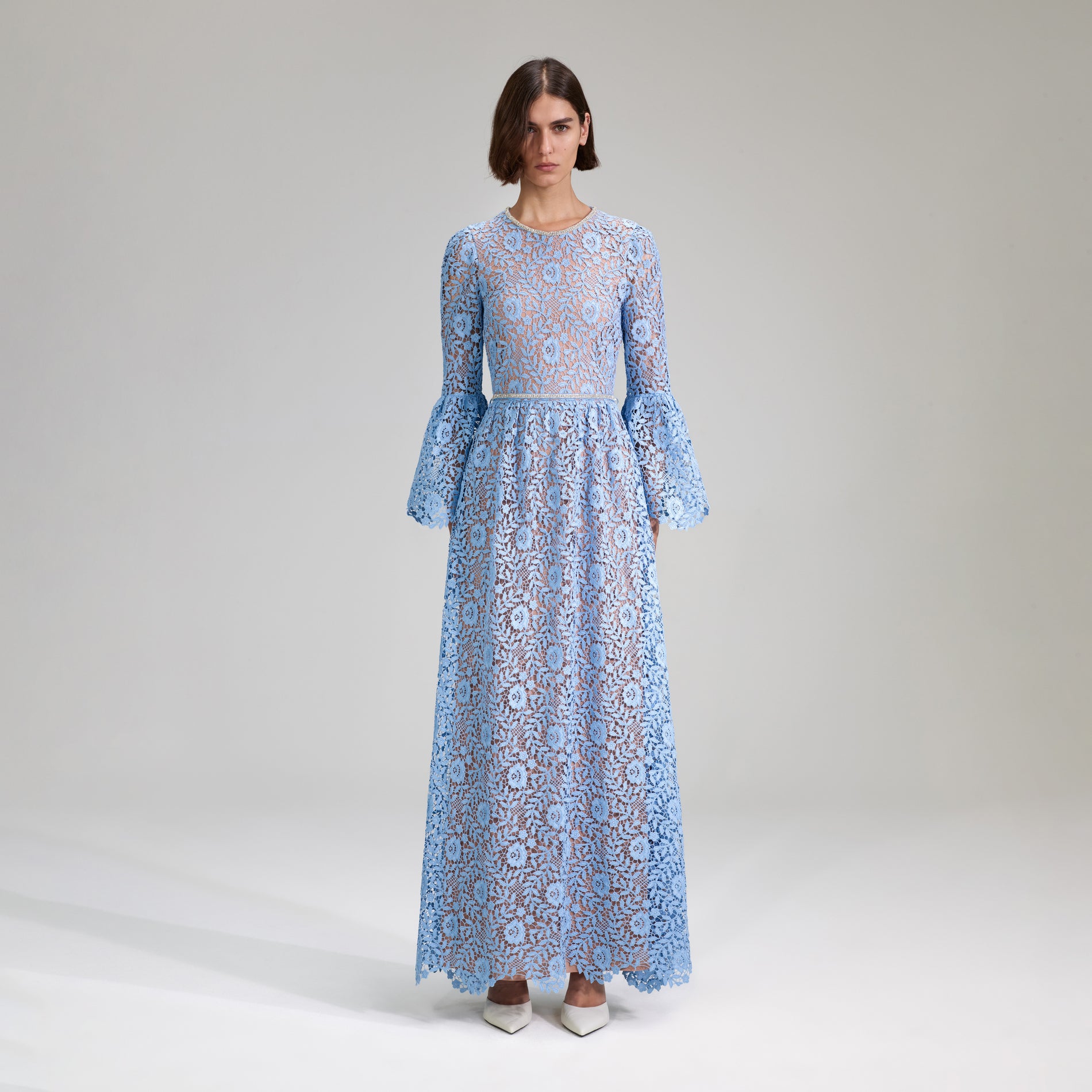 A woman wearing the Blue Rose Lace Maxi Dress