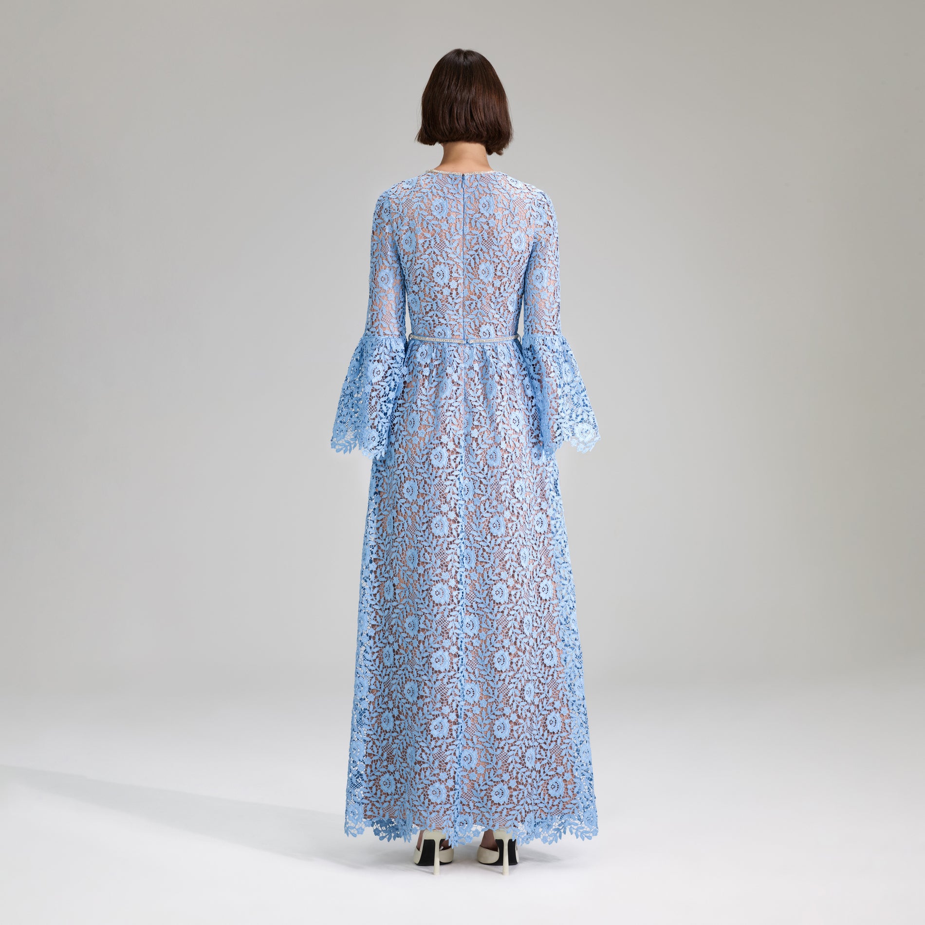 A woman wearing the Blue Rose Lace Maxi Dress