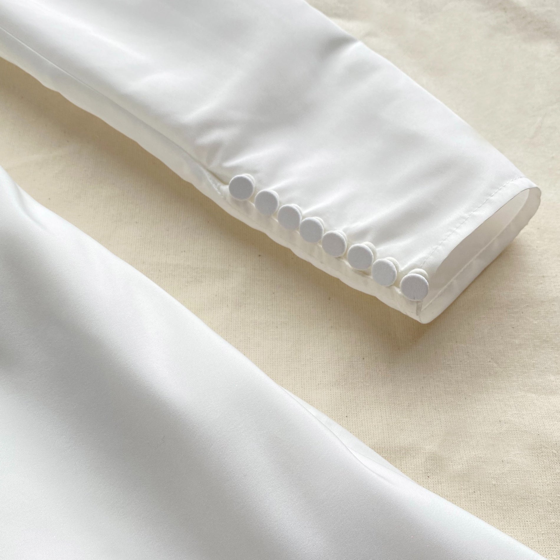 A close up of the fabric for the White Taffeta Mini Dress