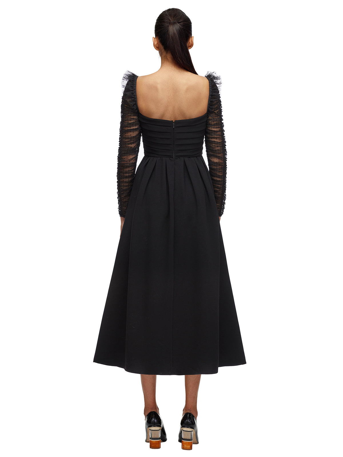 A woman wearing the Crepe Dot Mesh Sleeved Midi Dress