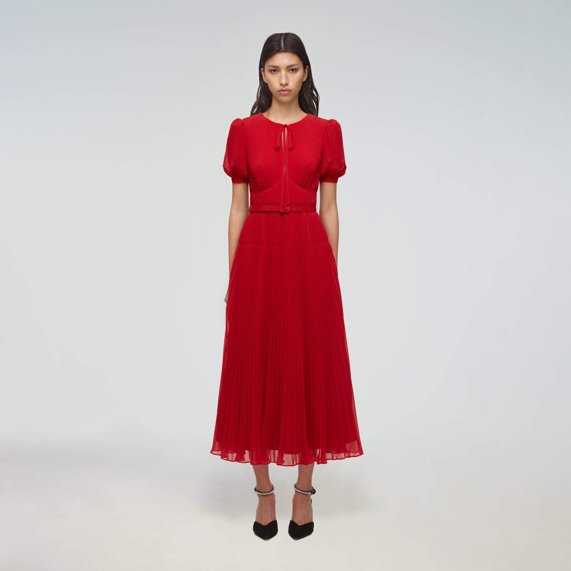 A woman wearing the Red Chiffon Midi Dress