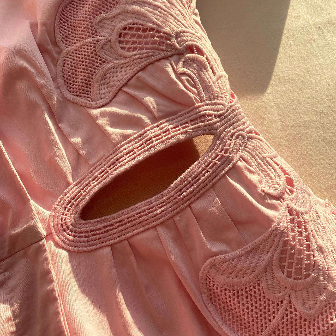 A close up of the fabric for the Pink Organic Cotton Cut Out Mini Dress